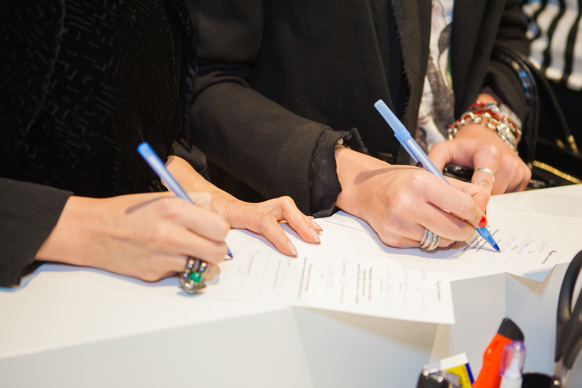 Women writing documents, signatures
