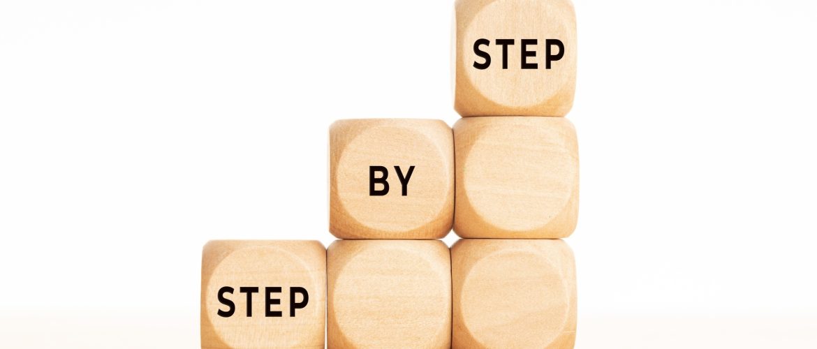 Step by Step phrase on wooden block shape